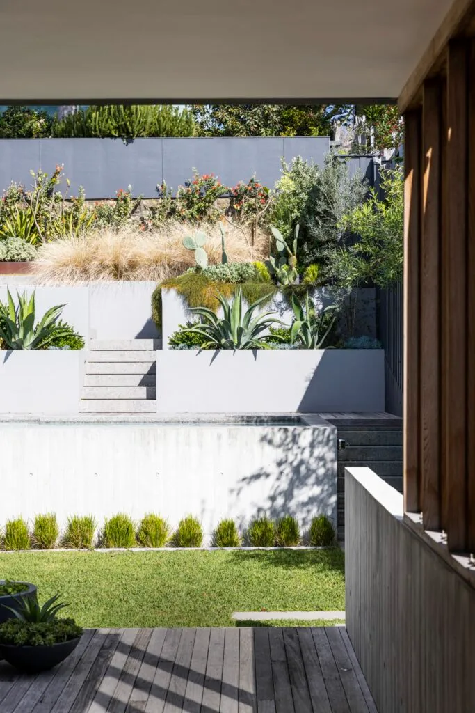 The deck and garden with steps leading up to the planters.