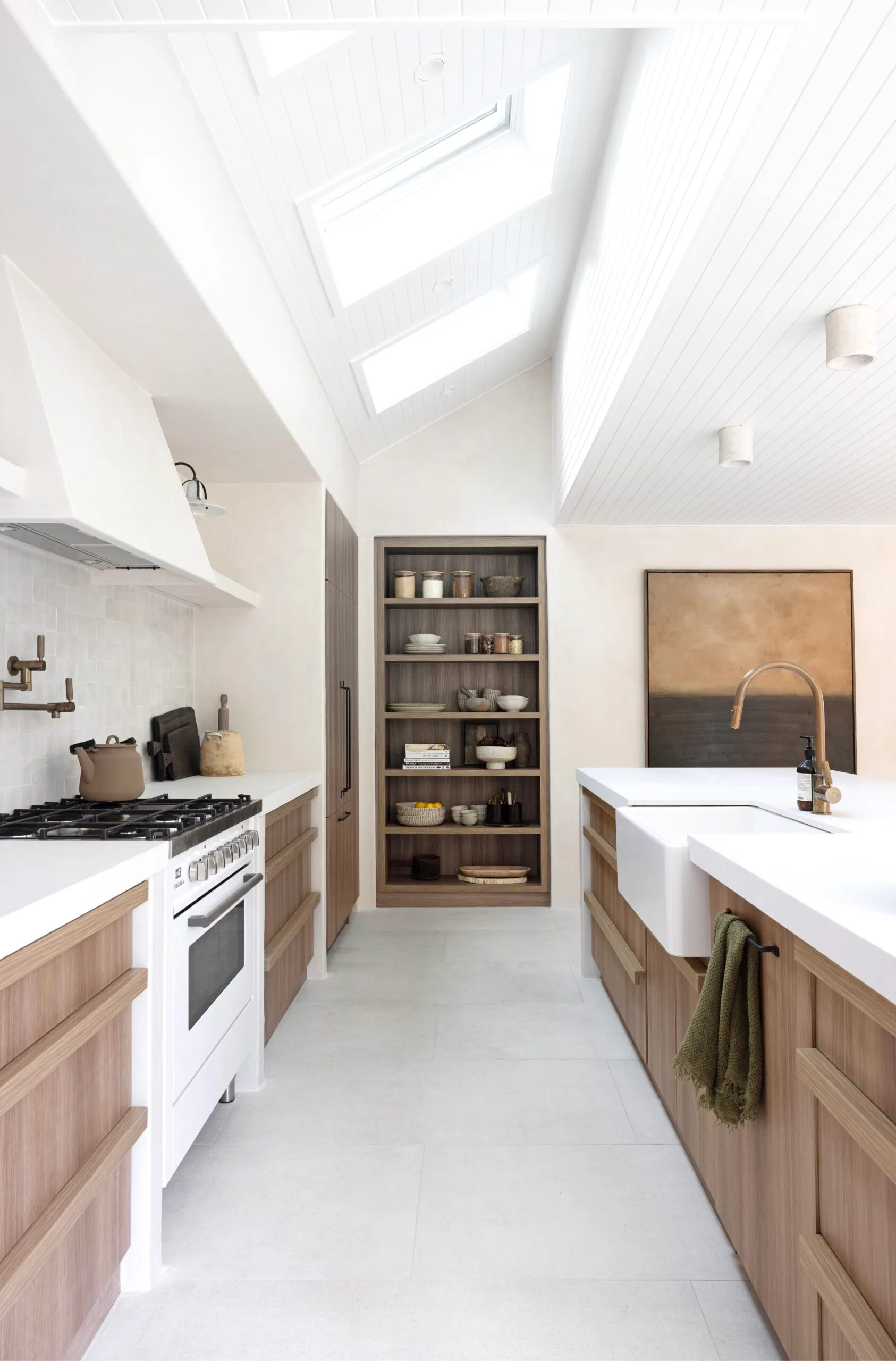 A neutral coastal kitchen with timber cabinets and an open shelf pantry.