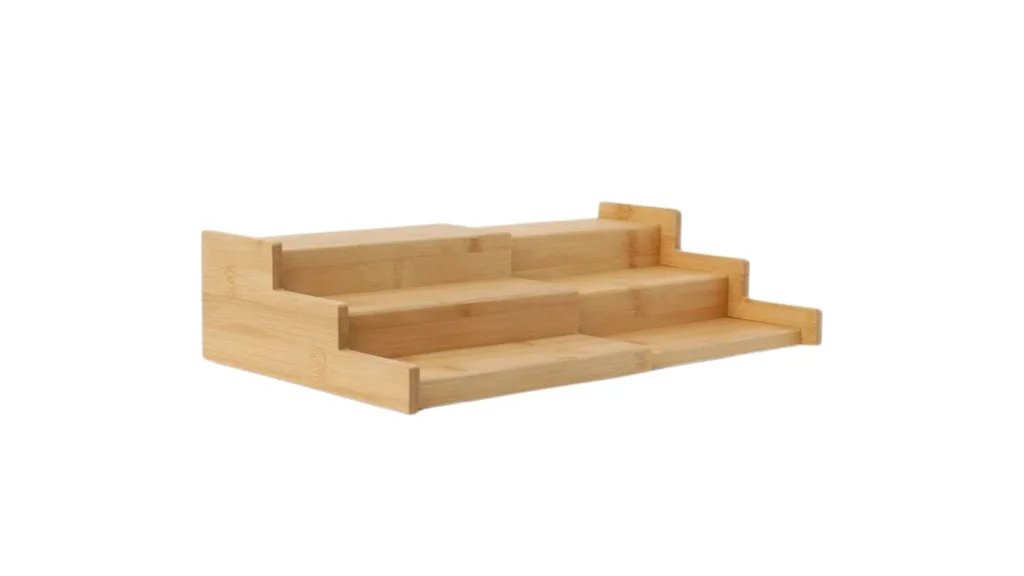 Three-tiered bamboo spice rack organizer on a white background.