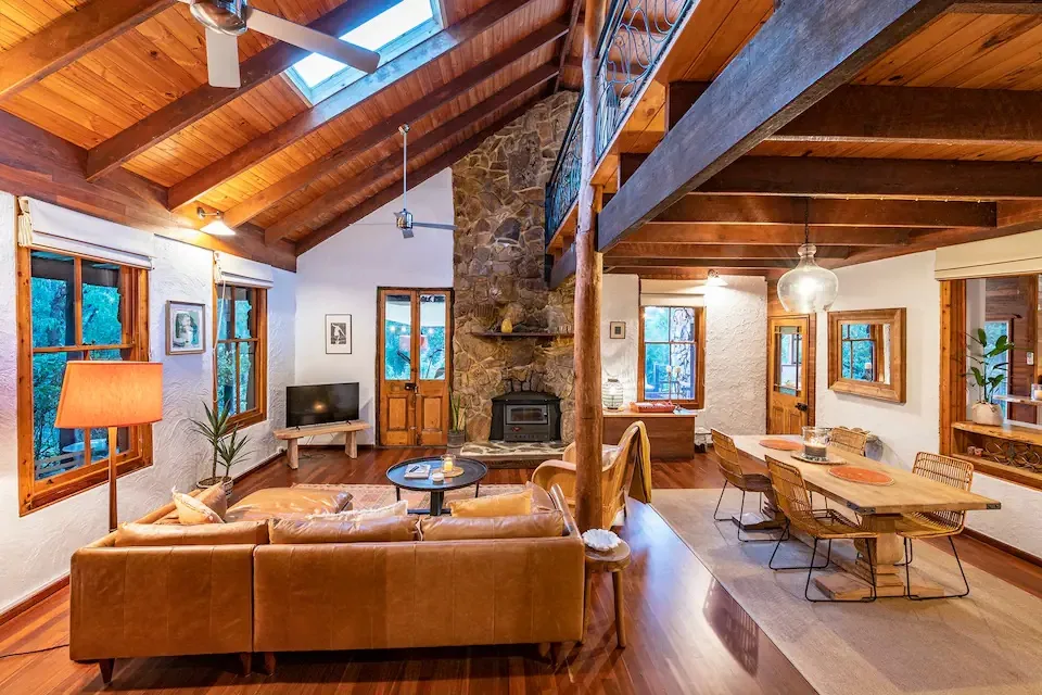 A large timber and stone cottage living room.