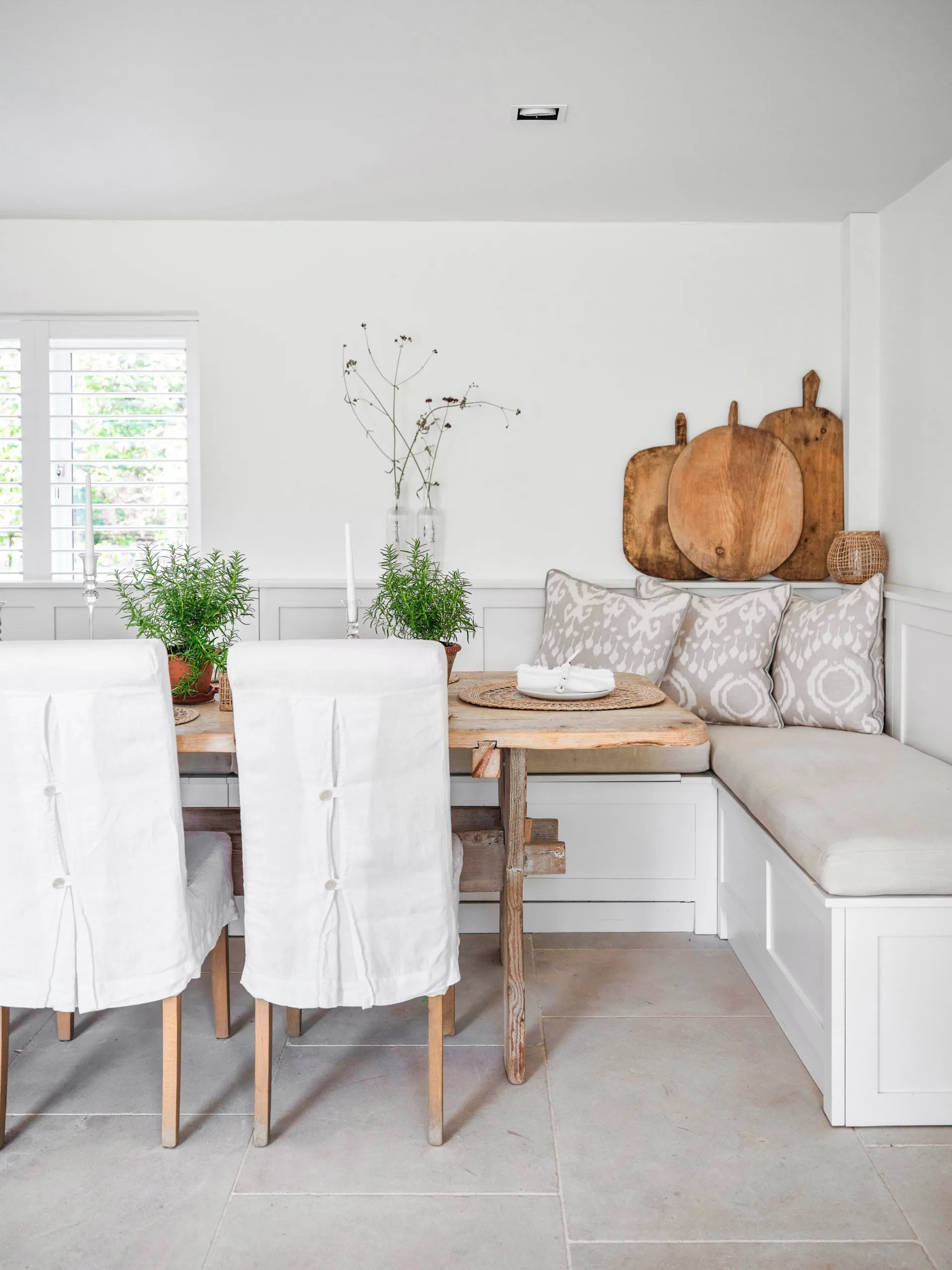 An antique timber dining table and bench in the dining room.