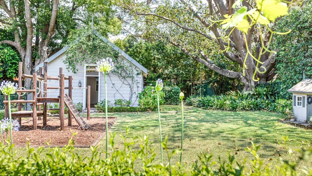 Backyard, lawn, studio and play area at the home of Recipetin Eats founder.