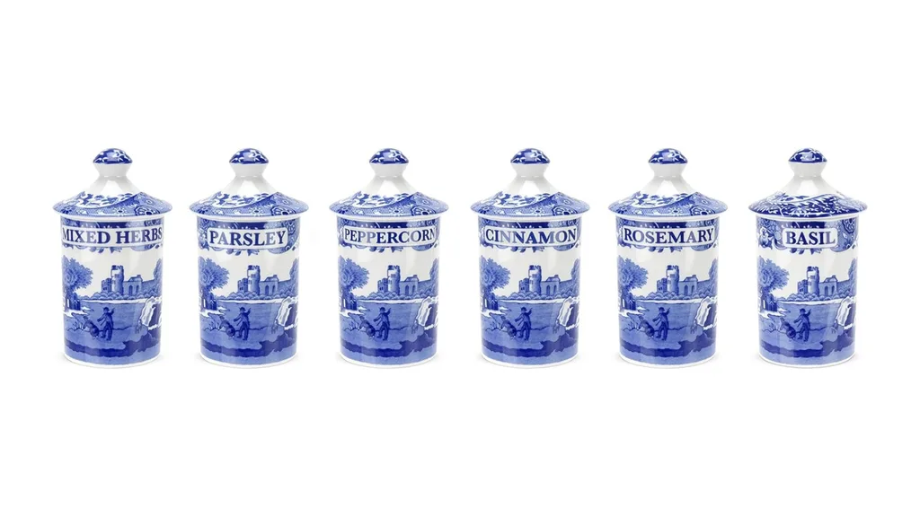 Blue and white ceramic spice jars labeled: Mixed Herbs, Parsley, Peppercorn, Cinnamon, Rosemary, Basil.