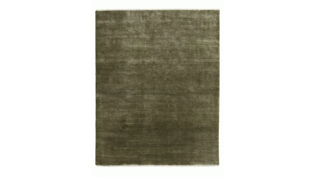 A deep green rug made from abrash-dyed wool