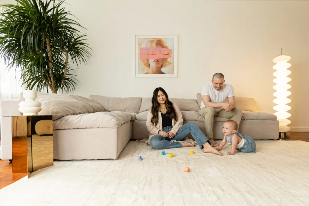 Miss Amara founder with her son and husband on a soft, fluffy rug