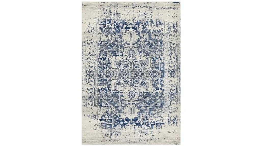 A Persian rug that is blue and white, with a distressed look