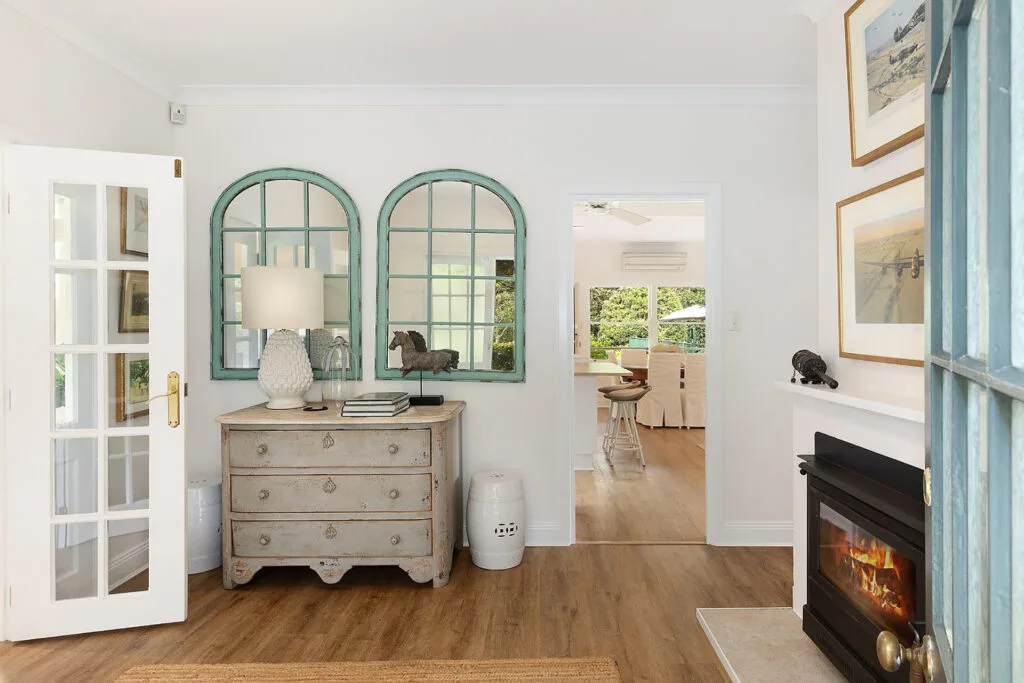 View of living room with two arched mirrors in Charlie Albone's Ourimbah weekender.