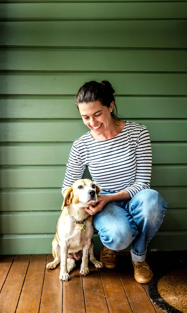 A portrait of owner Ainsley and her beagle.
