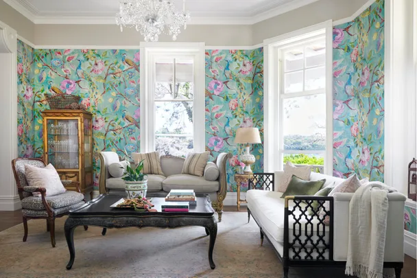 A formal living room with blue bird wallpaper and French furniture.