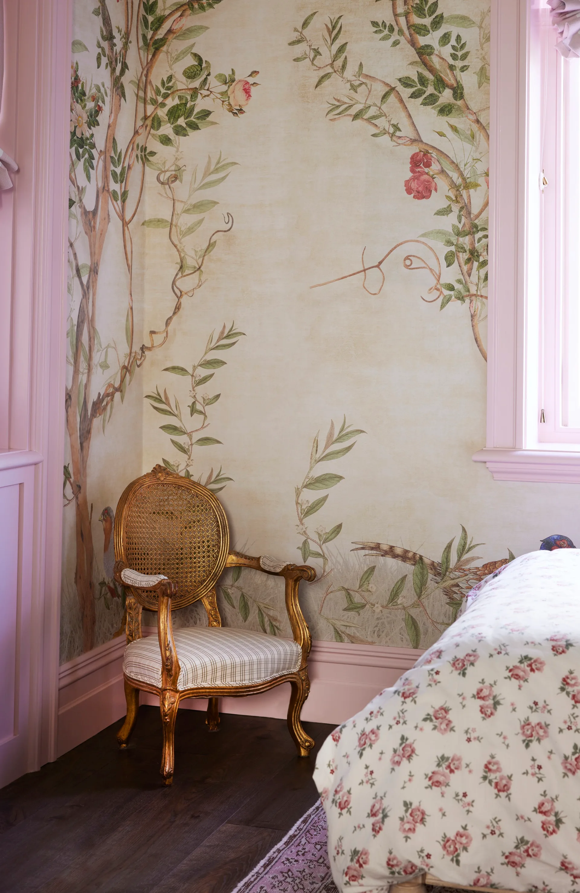 A vintage chair sitting in the corner of a children's bedroom.