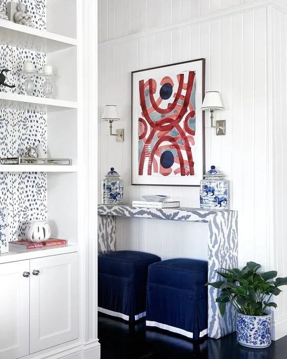 A classic Queenslander with all-American red, white and blue includes a red artwork above a table and ottomans in the entrance.