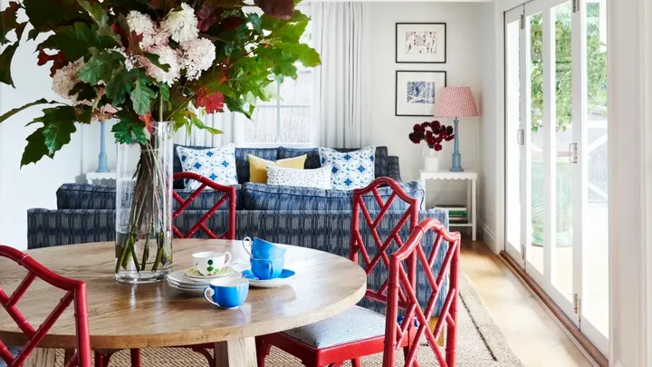 Dining and living area with pops of red and blue.