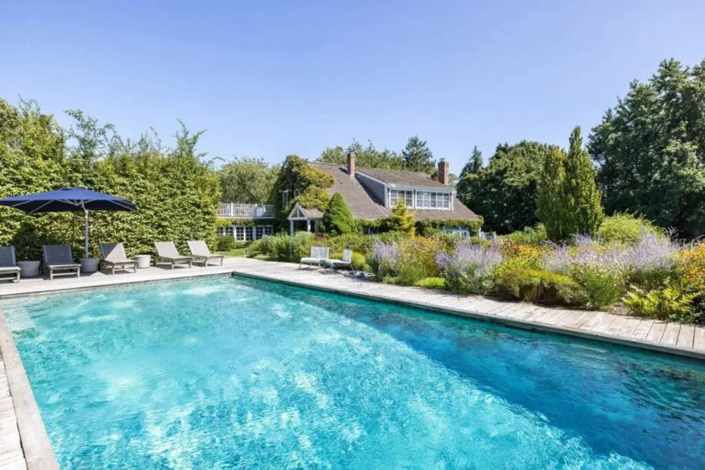 Drew Barrymore Hamptons home pool looking back at the house