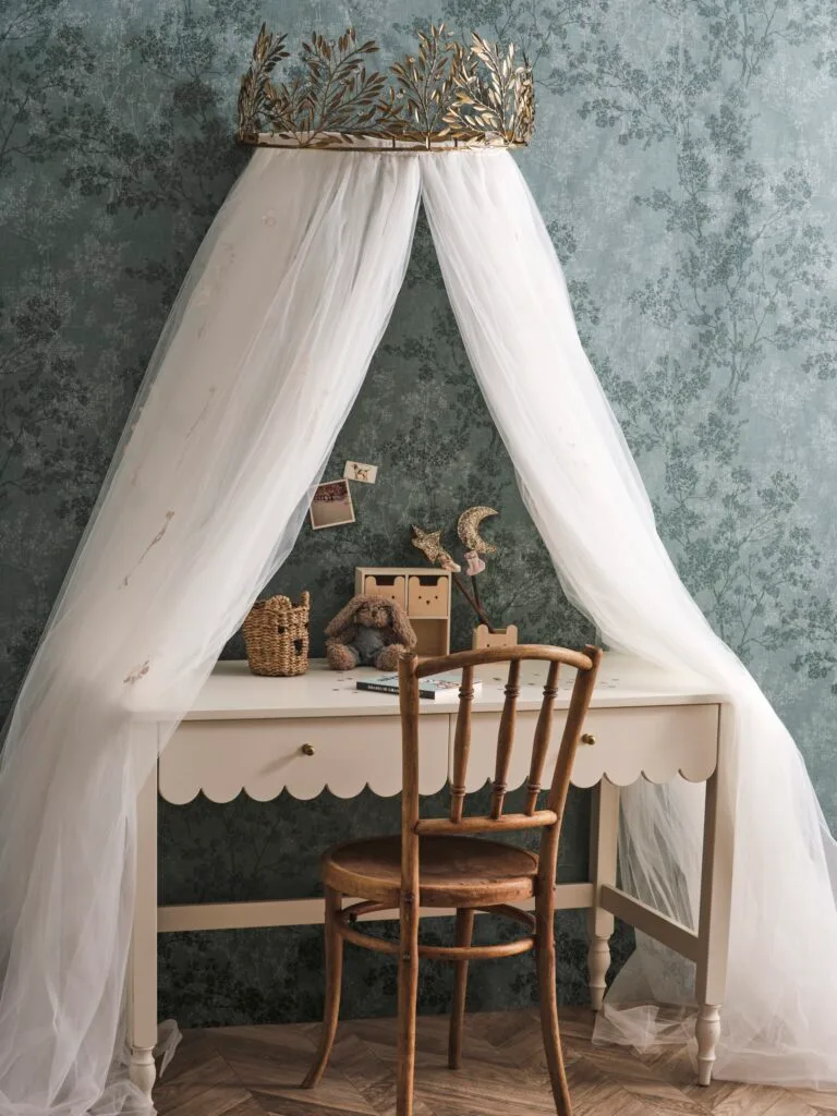 A kid's desk with a mesh overhanging canopy.