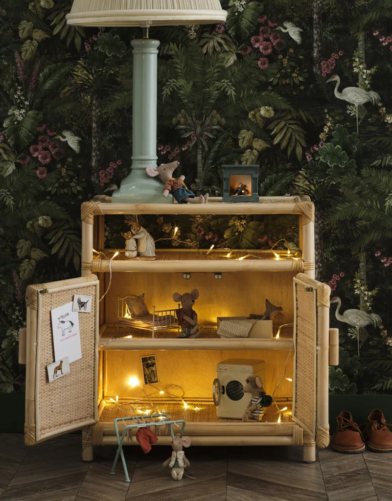 A kid's side table with fairy lights and toy mice.