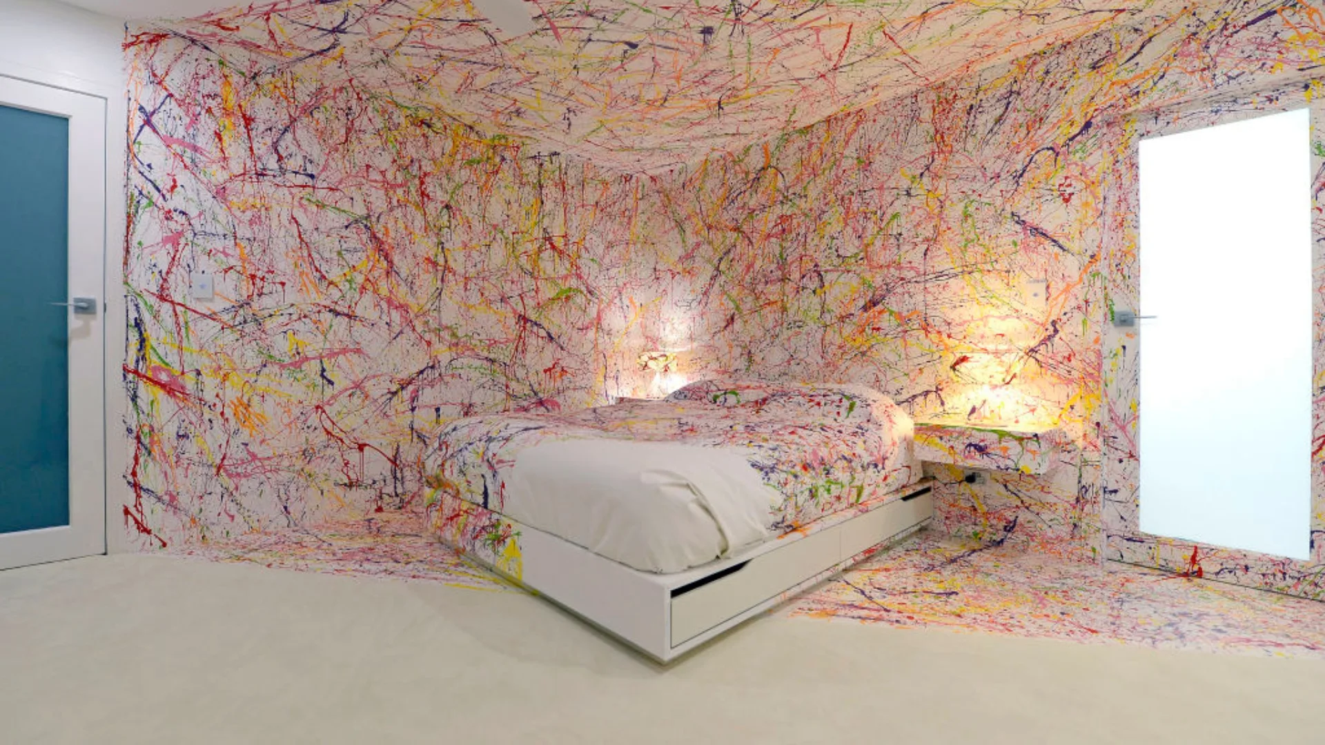Image of a white room splattered with colourful paint designed by Matt and Kim on The Block. It is often referred to as "the crime scene" bedroom.