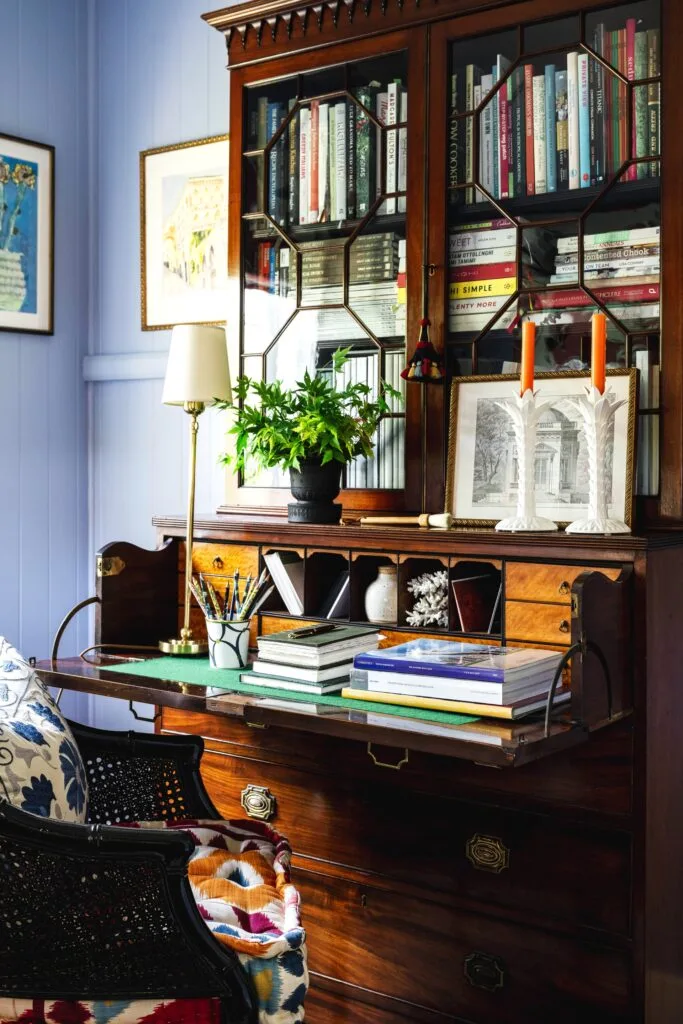 A study with a vintage timber and glass writing desk.