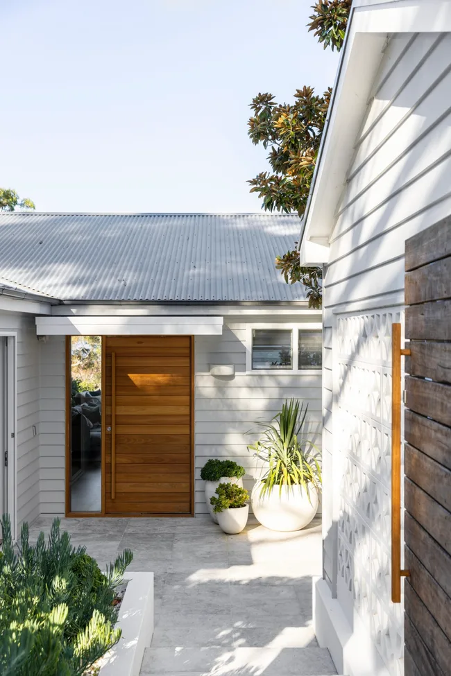 A weatherboard and breezeblock home entry way.