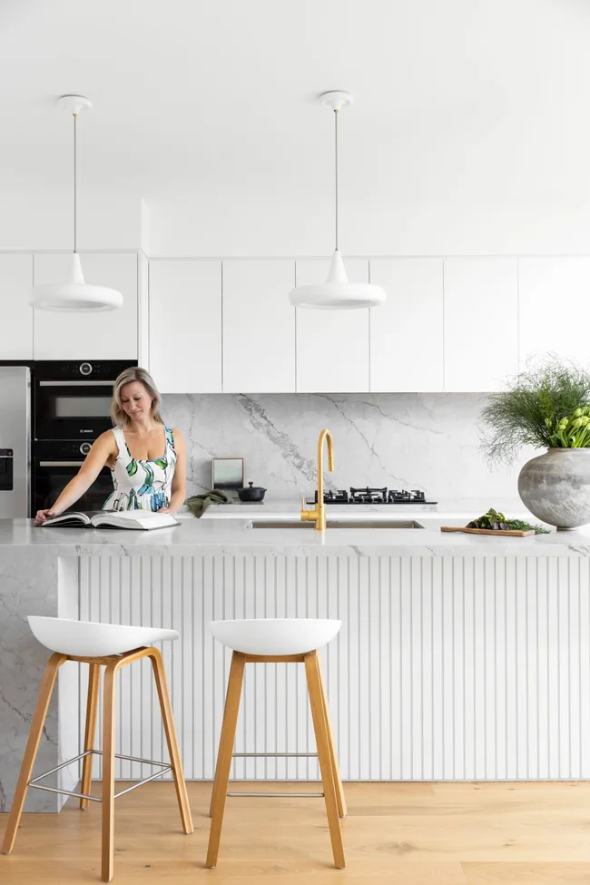 Owner Lisa standing at the kitchen island.