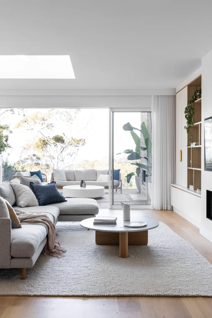 Coastal living room with white interiors and a skylight.