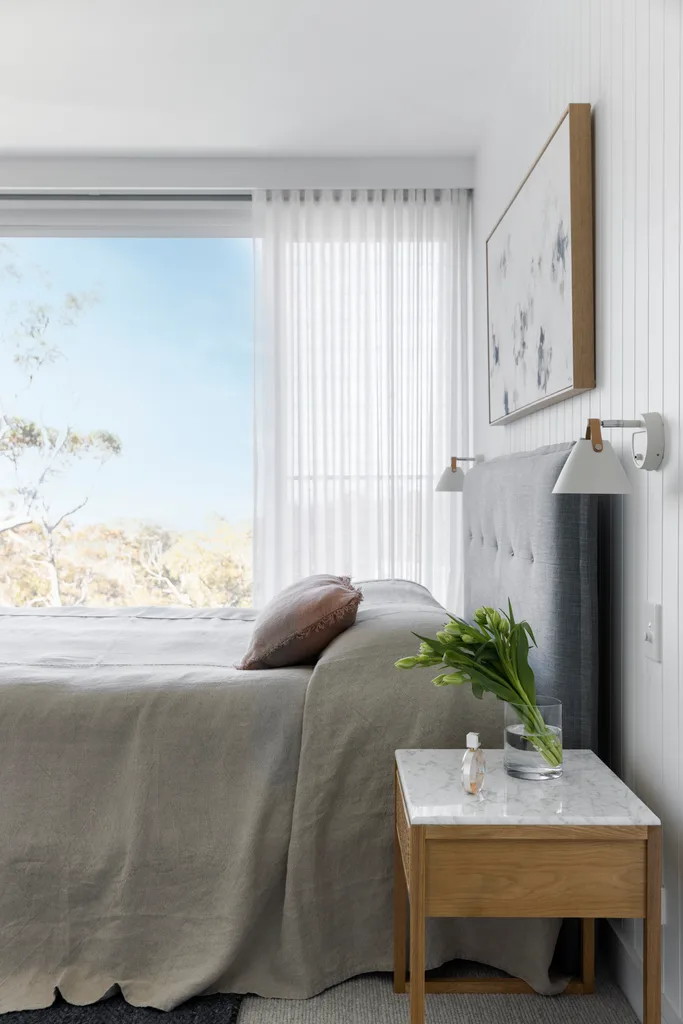 The main bedroom with an abstract artwork over a grey bed.