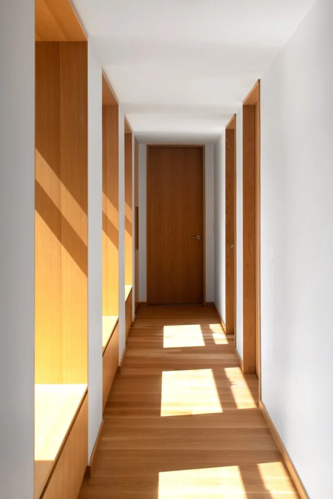 A minimalist white and timber hallway.