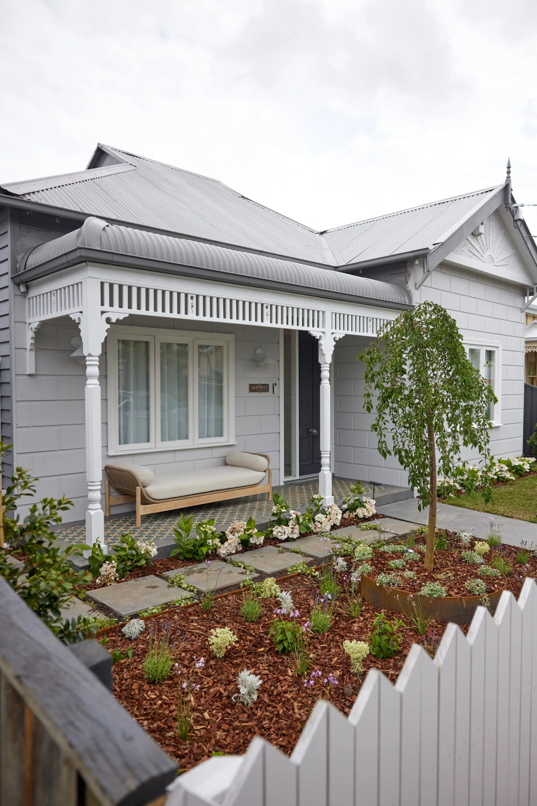 Brad and Mel from Dream Home's new facade is restored with fresh paint and lush landscaping