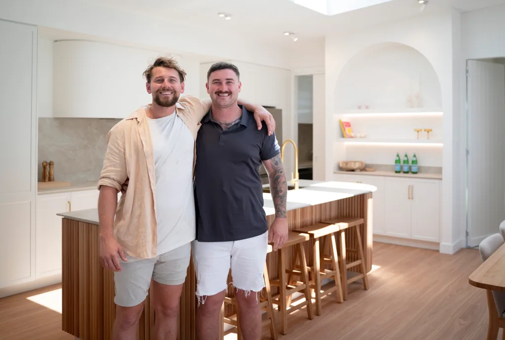 Dream Home team Rhys and Liam smiling side by side in Liam's new kitchen.