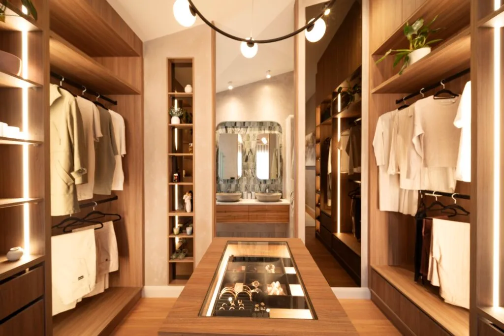 Elle's walk in robe has open timber shelving with a view through to the ensuite