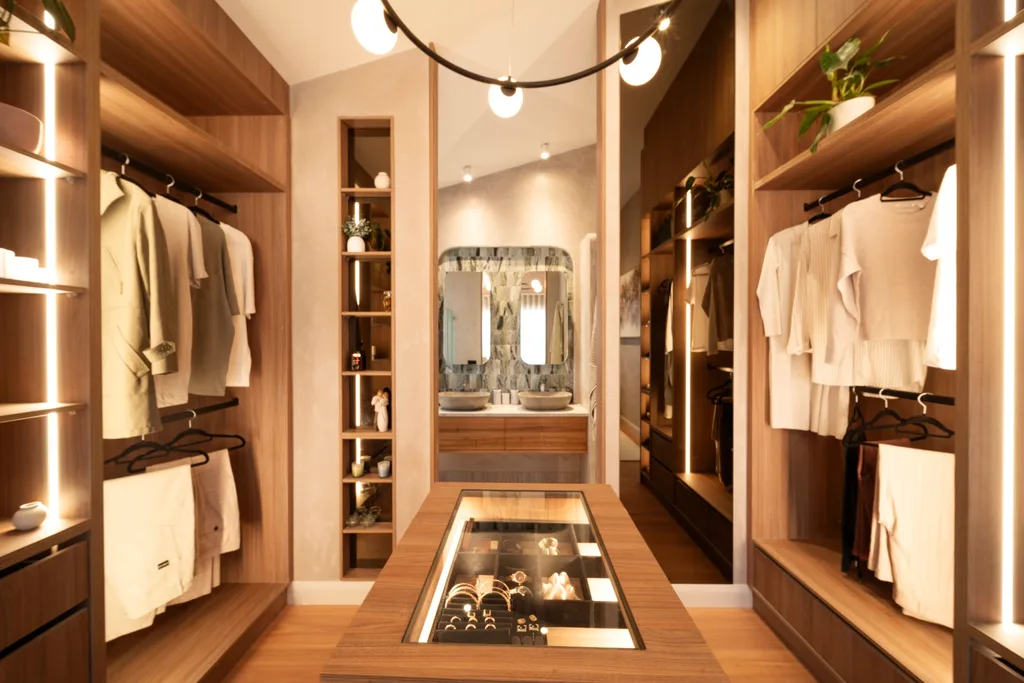 Elle's walk in robe has open timber shelving with a view through to the ensuite