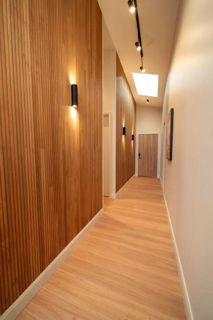 Elle's hallway is cladded in slim timber panels