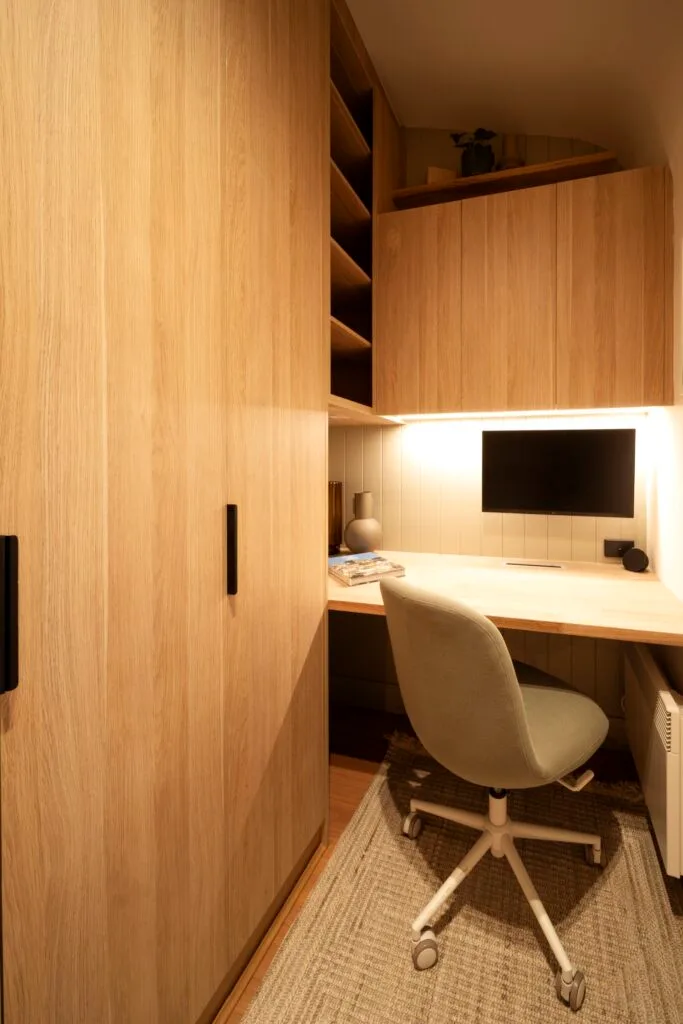 Elle's study had floor to ceiling cupboards and a desk with an office chair