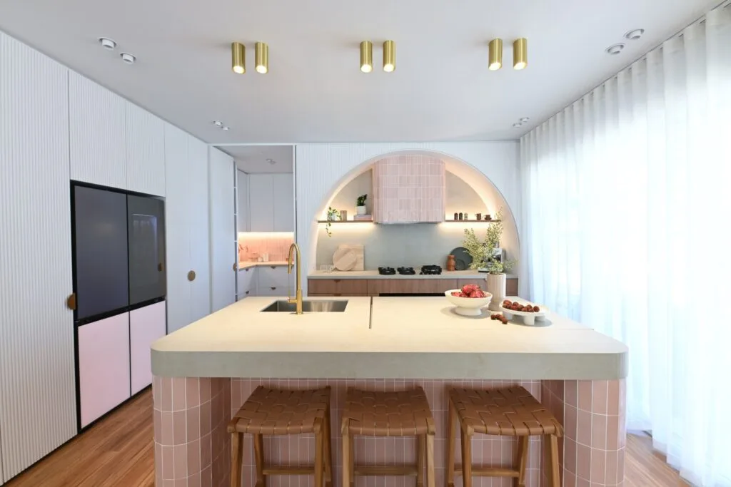 Hannah and Jonny's Dream Home kitchen with feature arch over pink tiled rangehood to match the tiled base of the island bench.