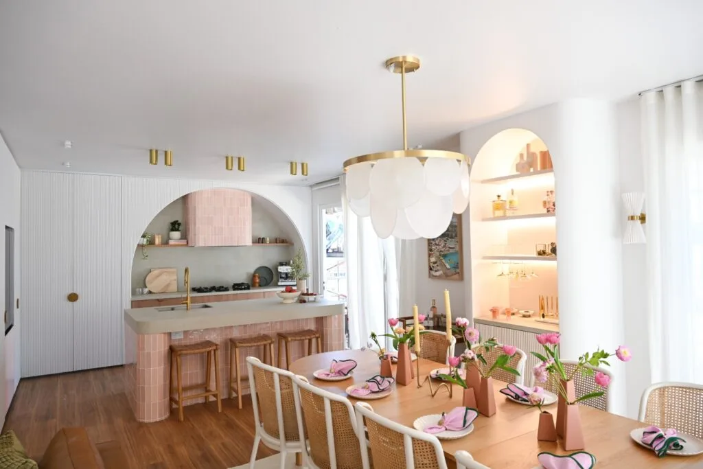 Hannah and Jonny's Dream Home dining room with a chandelier over a decorated table and an arched bar area built into the wall.