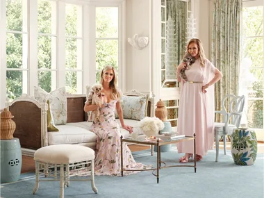 Nicky and Kathy Hilton sit on lounges on a pale blue Ruggable rug from their collection