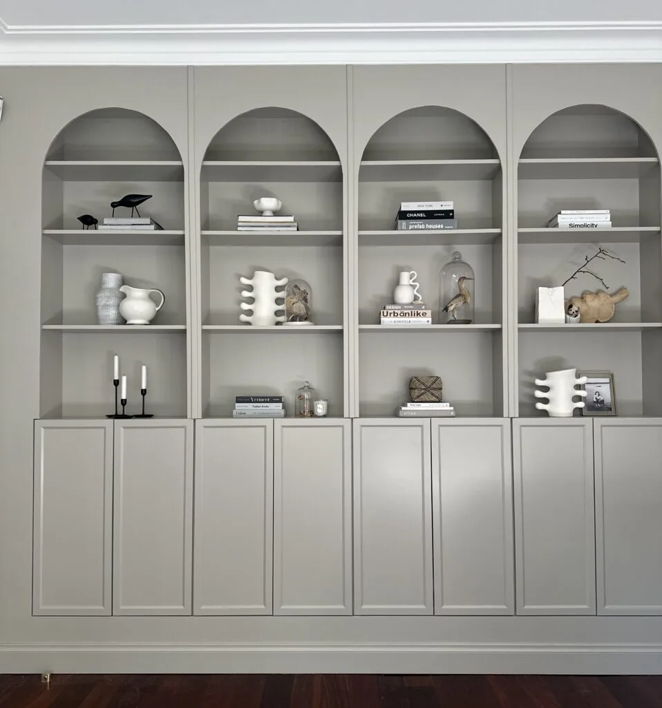 Ronnie and Georgia's completed cabinetry using Billy bookcases, with elegant arches painted in a warm grey.