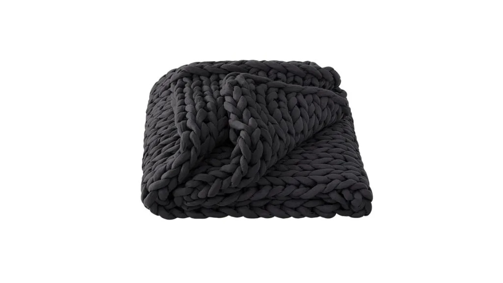 The Sheridan Sabine chunky knit blanket throw in Anthracite, which is a charcoal black, from David Jones.