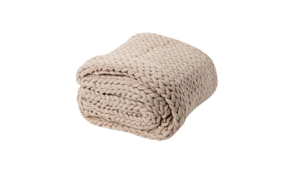 The Vue chunky knit blanket throw in Beige from Myer, folded. 