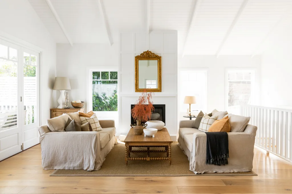 A white Hamptons style living area with linen sofas and raised ceilings.