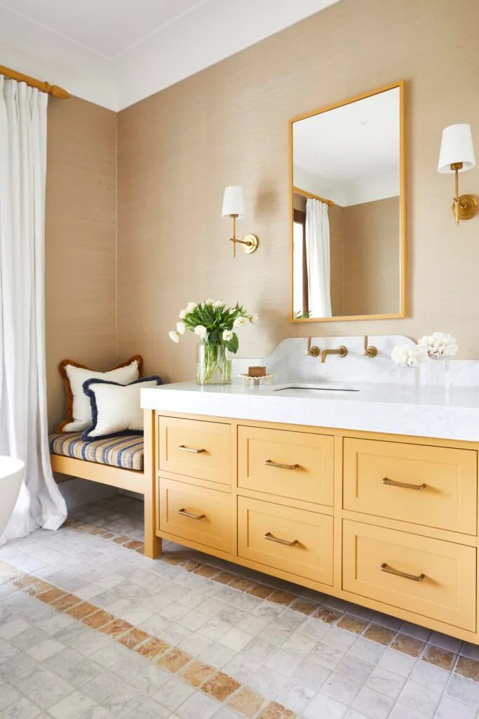 A large ochre vanity and bench in an ensuite.