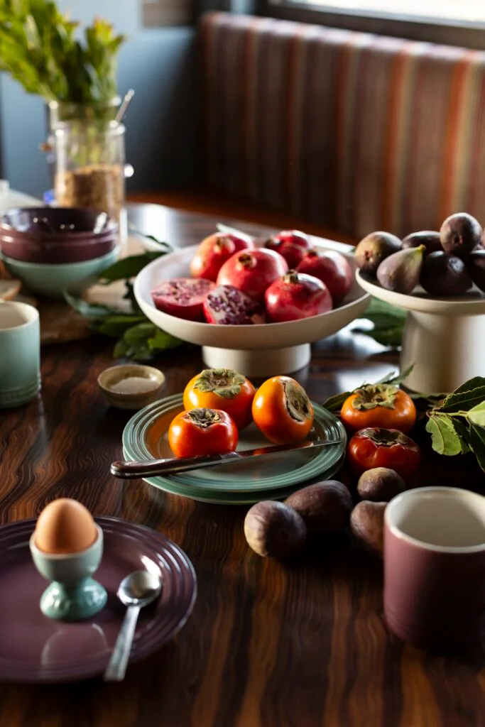 A tablescape with fresh fruits and breakfast foods.