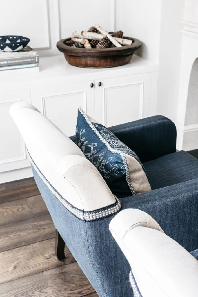 A blue and white armchair with a patterned cushion.