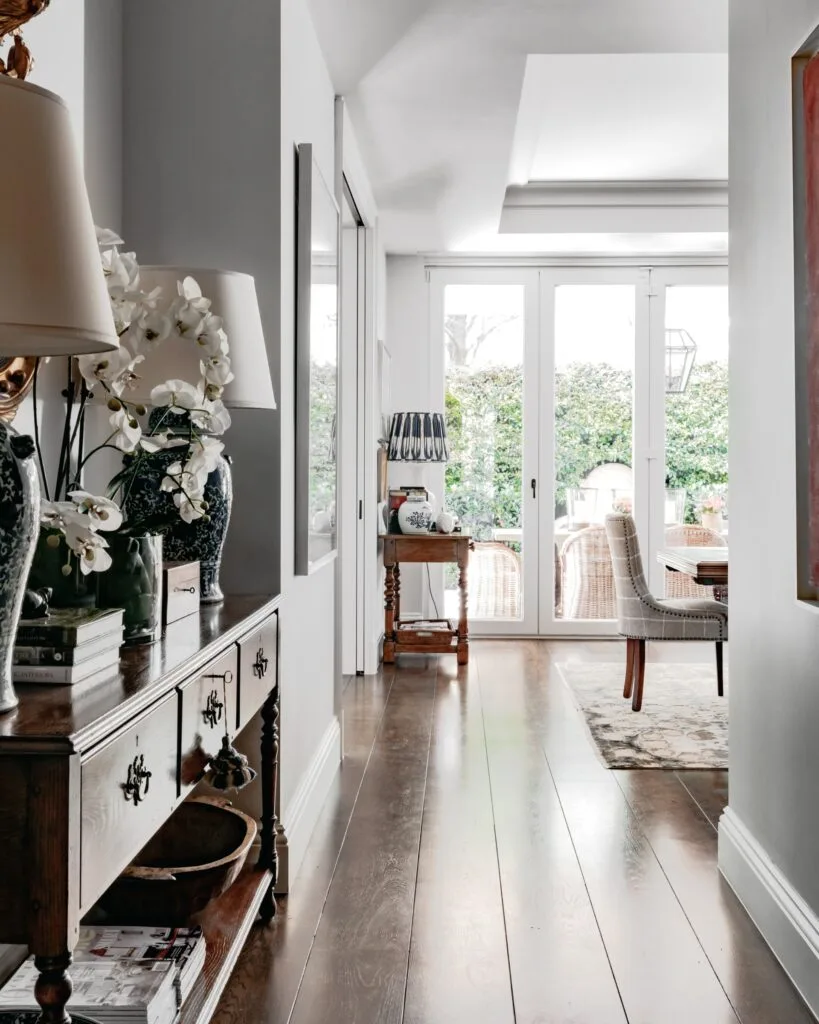 A hallway leading into a formal dining area.