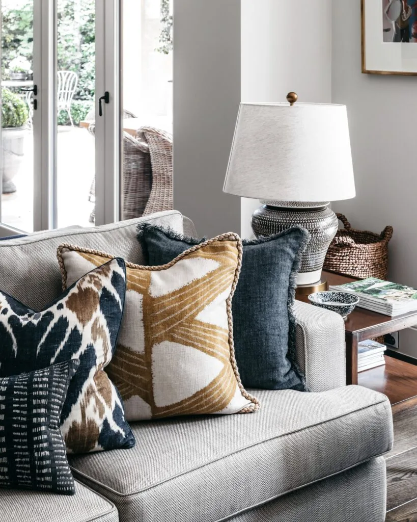 A grey sofa with a collection of classic patterned cushions.