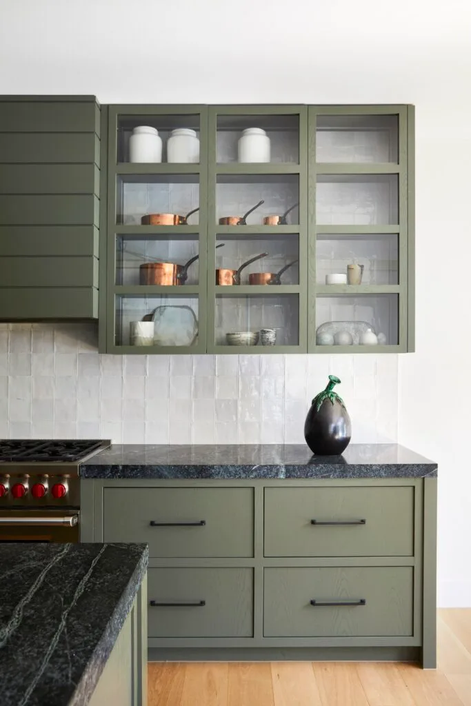 A modern farmhouse style kitchen with greige cabinetry and drawers.