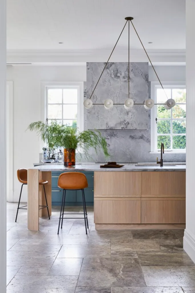 A Dutch-inspired kitchen with a quartzite splashback and travertine floors.