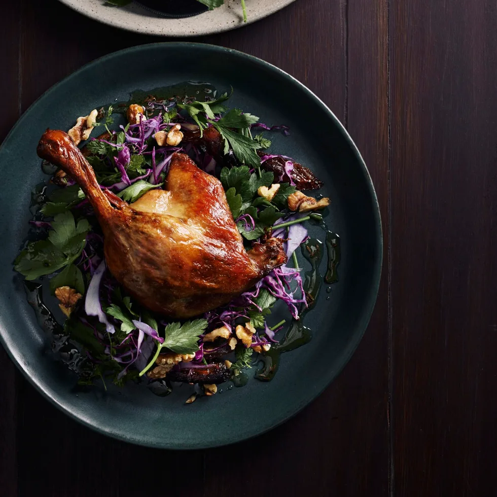 Two servings of winter slaw with red cabbage, blistered dates and confit duck.