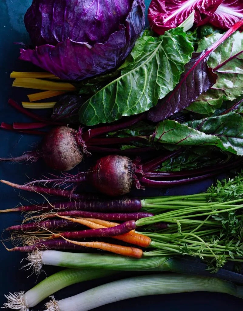 Winter vegetables including beetroot, carrots, leeks and cabbage.