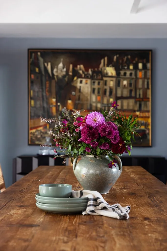 Blue crockery and ceramics on a timber dining table.