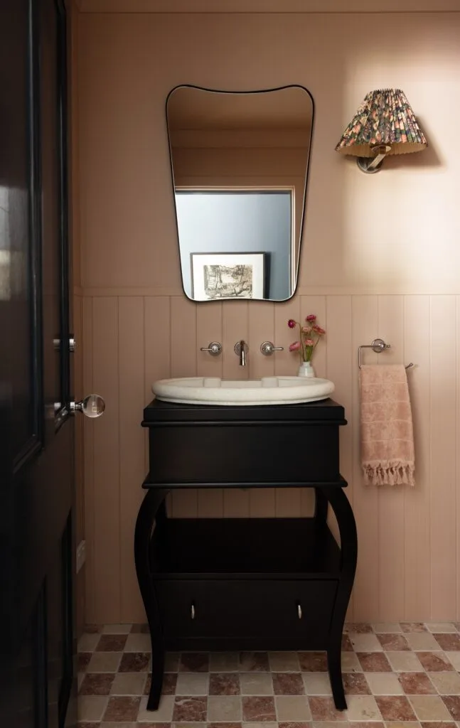 A powder room with VJ panelling and a vintage pedestal basin.